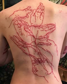 the back of a woman's body with red ink on it