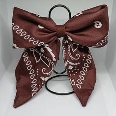 a brown and white bow on a black stand