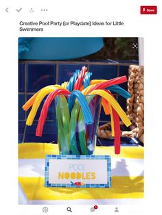 a vase filled with colorful plastic straws on top of a table