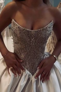 a woman in a wedding dress with her hands on her hips