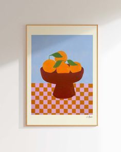 oranges in a bowl on a checkered tablecloth