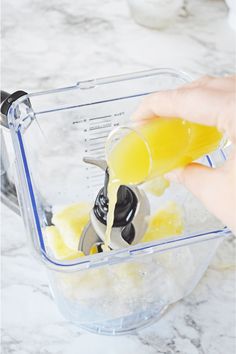 someone is pouring yellow liquid into a blender to make homemade ice cream for desserts