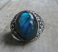 solid large labradorite ring mans wedding or dress ring beautiful scroll antique effect. solid sterling silver (925) Solid not hollowed out in the back stone flashes blues and grey with black flecks..few inclusions. Avaliable in many stones Stone measures 17 mm x13mm (6/8 ''x 4/8'' approx.) The stone will be set once sold.1 This ring I can make any size. It weights 12.2 gms approx It is 21mm (7/8 '' wide) It tapers to 3.5mmat the back If a different size is required pls convo me Spiritual Open Ring Jewelry For Formal Occasions, Elegant Metal Rings With Stone Setting, Metal Promise Ring, Silver Jewelry With Large Round Stone, Fine Jewelry With Large Silver Stone, Vintage Silver Crystal Ring With Large Stone, Adjustable Moonstone Jewelry With Round Stone, Sterling Silver Open Ring Jewelry Engraved, Elegant Silver Jewelry With Large Stone