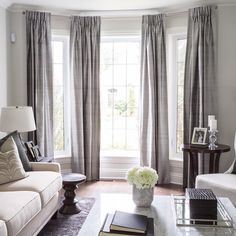 a living room with two couches, a coffee table and pictures on the wall