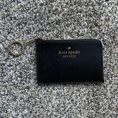 Black With Gold Lettering And Zipper Wallet, Never Used, Perfect Condition Compact Black Card Holder Gift, Compact Black Card Holder As Gift, Black Card Holder With Key Clip For Travel, Black Card Holder With Zipper Closure As Gift, Kate Spade Coin Purse With Card Slots As Gift, Black Card Holder With Interior Key Chain As Gift, Keychain Wallet, Gold Lettering, Kate Spade Accessories