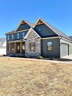 a gray house with stone and wood accents