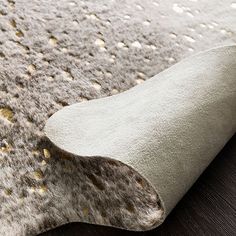 a close up view of a rug with gold dots on the top and bottom of it