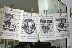 sheet music are hung over an old typewriter with the word love spelled on it