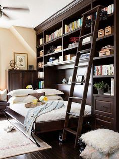 a bedroom with bookshelves and a ladder to the bed in front of it