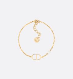 The Petit CD bracelet has an elegant and streamlined aesthetic. The style is comprised of a thin gold-finish metal chain showcasing a 'CD' signature at the center. A small white resin pearl completes the look. Modern and refined, the bracelet may be worn with other Petit CD creations.. Dior Pearl Bracelet, Bracelet Cd, Dior Bracelet Gold, Cd Bracelet, Bracelet Dior, Christian Dior Jewelry, Christian Dior Bracelet, Dior Bracelet, 24 Birthday