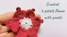 the crochet flower is being held in someone's hand with text overlay