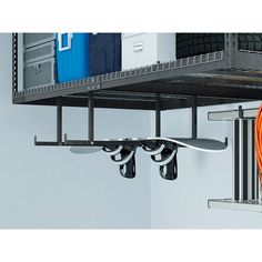 an orange hose is connected to the side of a wall mounted garage storage rack with hooks