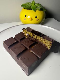 a chocolate bar sitting on top of a white counter next to a yellow planter