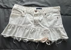 RARE Finds Vintage Y2K Abercrombie & Fitch white denim ruffle raw hems pink stitch mini skirt. In good clean, excellent condition with no noticeable stains.  Size: 2 ( waist flat measurement at 15")  It can fit anywhere from size 28-30" Skirt does not stretch.  Please refer to pictures for all details.  Reasonable offer accepted. White Denim Skirt With Frayed Hem For Spring, Ruffled Cotton Denim Mini Skirt, Cotton Ruffled Mini Denim Skirt, Ruffled Mini Length Denim Skirt, White Denim Mini Skirt, White Jean Skirt, Mcbling Fashion, Y2k Abercrombie, Mini Skirt White