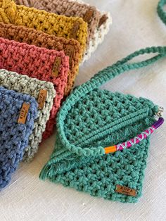 four crocheted purses sitting on top of a table