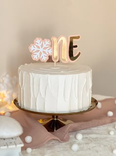 a white frosted cake sitting on top of a table