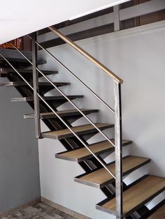 a set of metal stairs with wooden treads