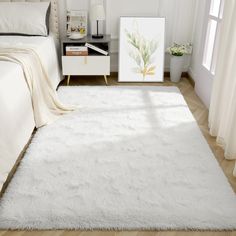 a white rug is in the middle of a room with a bed, nightstand and window