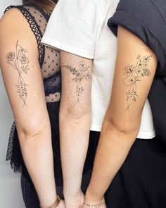 two people with tattoos on their arms