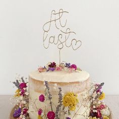 a cake decorated with flowers and the word fiesta on top