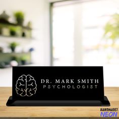 a black business card holder with the words dr mark smith psychologist on it