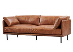 a brown leather couch with two pillows on it's back end and black legs