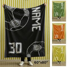 a person holding up a black and white towel with the number 30 printed on it