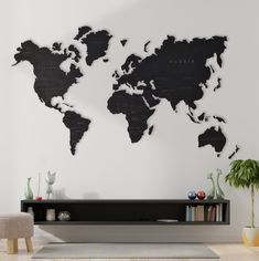 a living room with a large black world map on the wall