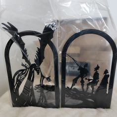 the silhouettes of two people on horses are in plastic bags