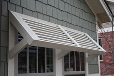 a white bench sitting in front of a building