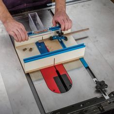 a man working on a piece of wood with a planer and tools attached to it