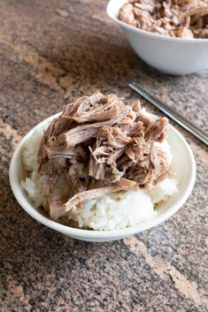 a white bowl filled with meat and rice