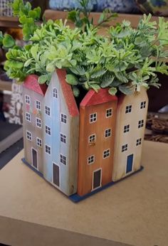 a house shaped planter sitting on top of a table