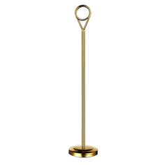 a gold metal toilet brush holder with a circular handle on an isolated white background for use in the bathroom