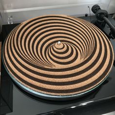 a black and brown circular object on top of a stove with an electric burner