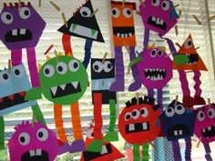 some paper monsters are hanging on the wall