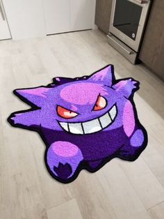 a purple rug with an angry face on the floor next to a stove top oven