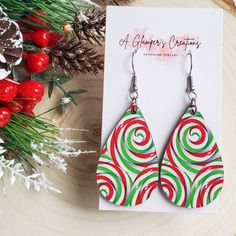 Red, Green, & White Swirl Wooden Christmas Teardrop Earrings Earrings are made of high quality printed wood. The design is the same on both front and back of the earrings. Dimensions: approximately 1.75 inches Hooks are hypoallergenic stainless steel and come with rubber backings on an earring card. Please note that the print placement may vary for each pair of earrings due to where it is cut from. Christian Boutique, Teacher Earrings, Earring Card, Earrings Teardrop