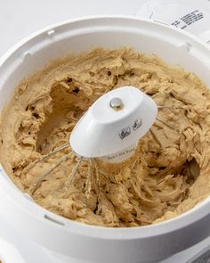 a white bowl filled with batter sitting on top of a counter