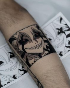 a man's arm with a tattoo on it that has an image of the joker