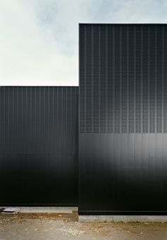 two tall black buildings sitting next to each other