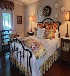 a bed sitting in a bedroom next to two lamps on either side of the bed