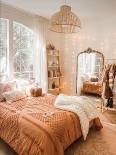 a bedroom with an orange comforter and pillows