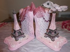 two pink glass figurines with the eiffel tower on them