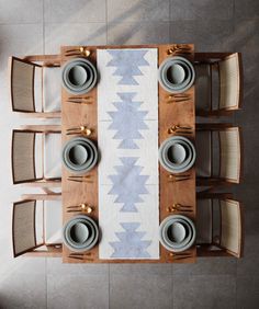 an overhead view of a dining room table with place settings and place mats on it