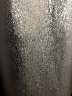 closeup of silver leather textured surface with no visible patches on the bottom part