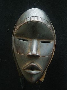 an african mask is displayed on a black background