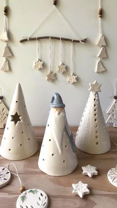 three ceramic christmas trees on a table