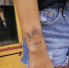 a woman's arm with a tattoo on the wrist and stars in the middle