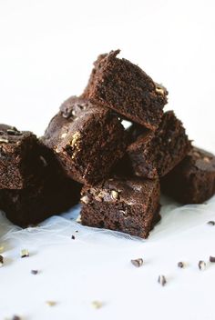 a pile of brownies sitting on top of a white table